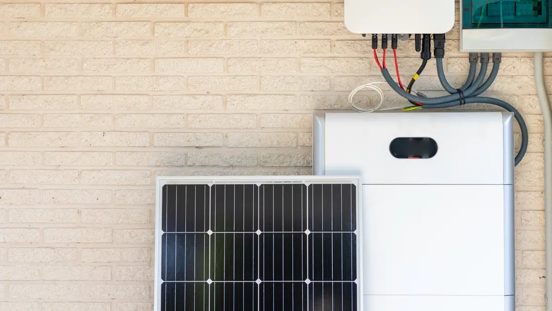 A home battery and inverter mounted on a wall